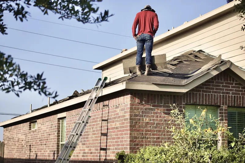 Professional roofer working on a residential roof in Missouri City